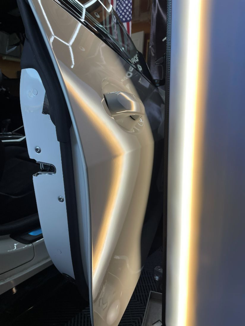 The same white door after paintless dent repair
