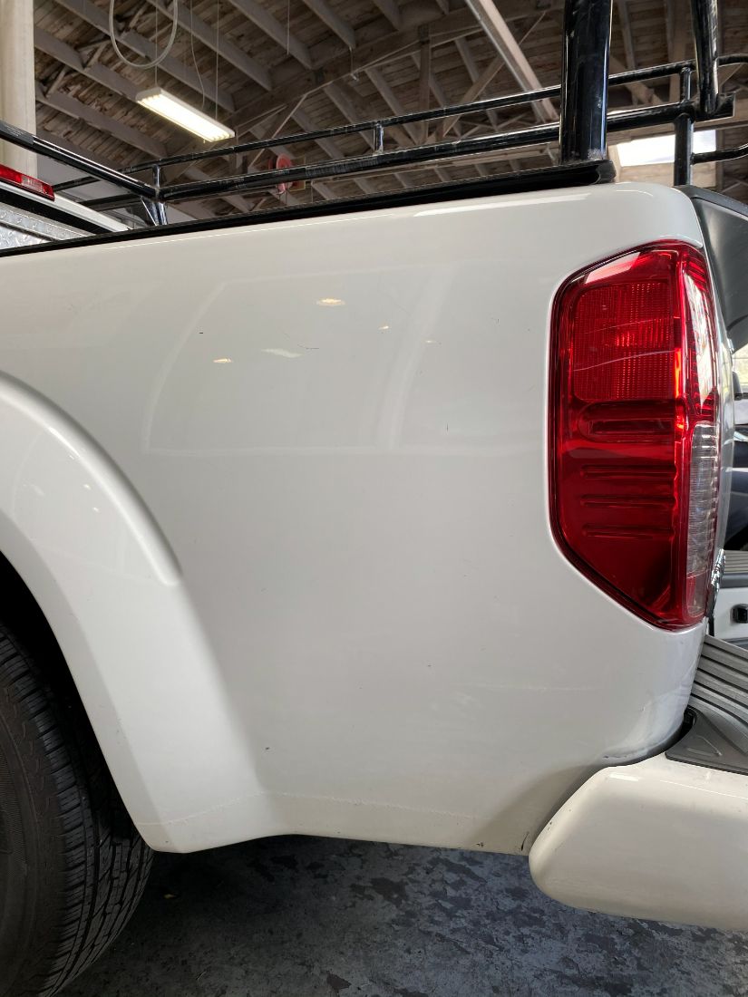 The same truck bed after paintless dent repair